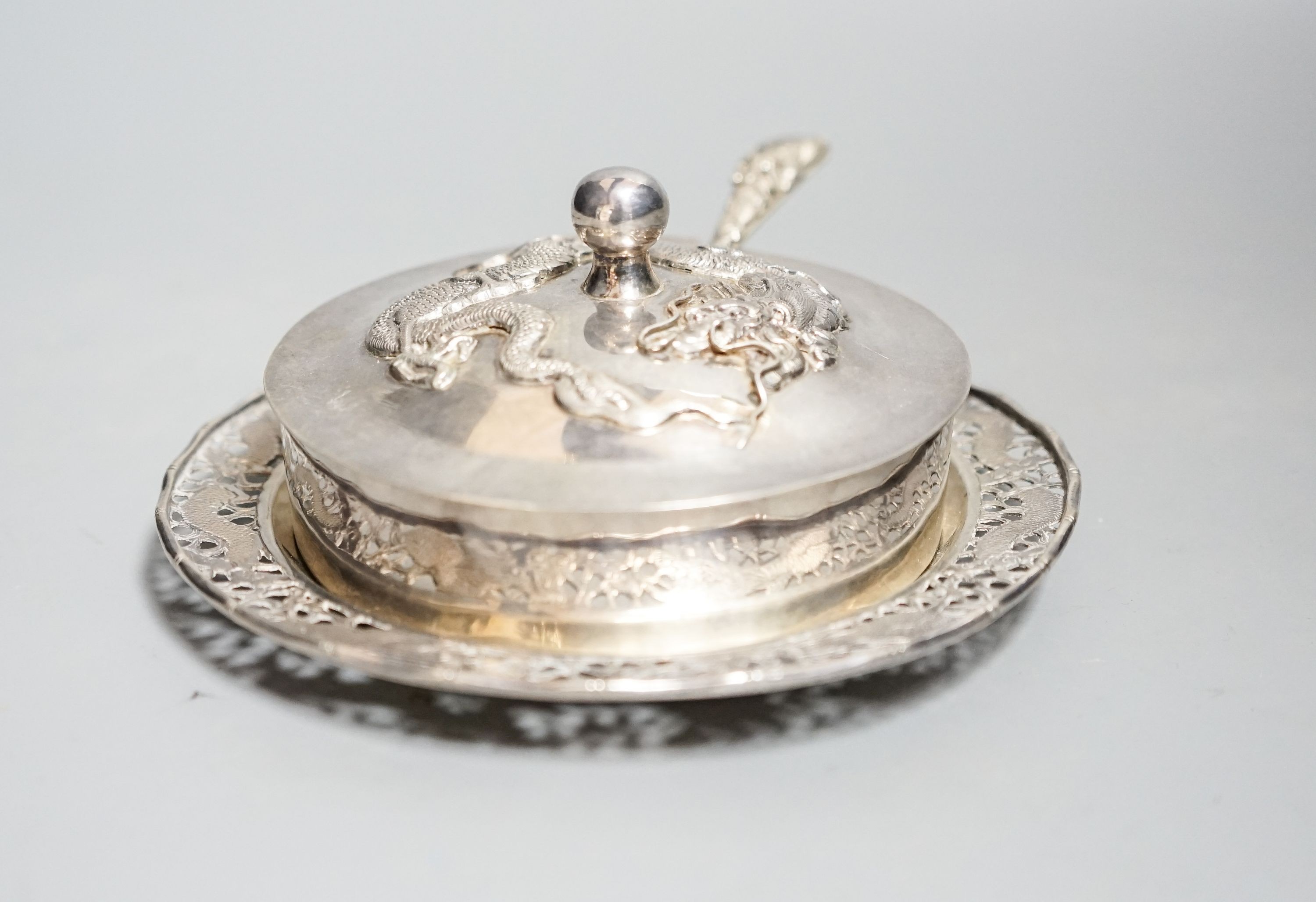 A Chinese white metal butter dish, on stand with knife by Tack Hing, with glass liner, 14.2cm.